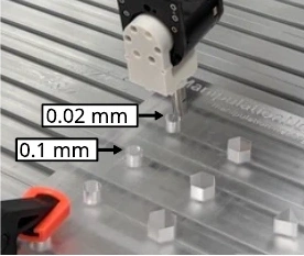 Robot-held peg and tight-clearance holes on the insertion plate.